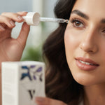 Applying eyebrow and lash serum along lash roots
